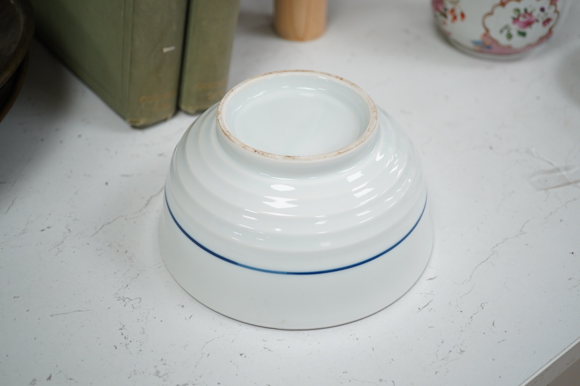 A group of Chinese blue and white porcelain, including a mid 19th century Canton enamel teabowl and a Japanese small dish, tallest 22cm. Condition - fair